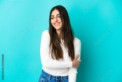 Young caucasian woman isolated on blue background laughing © luismolinero
