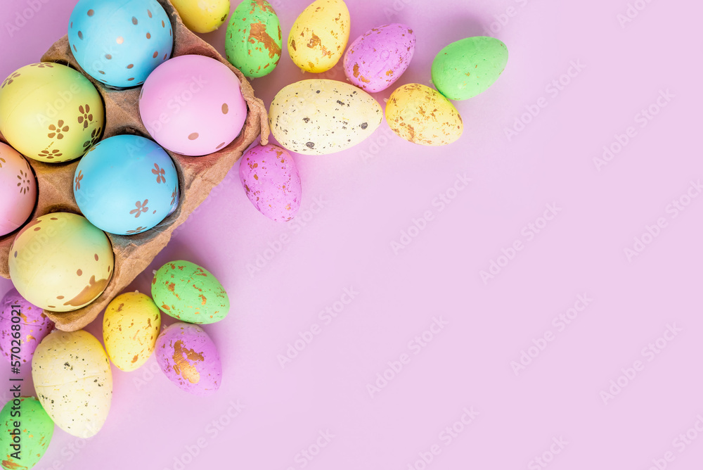 Close-up of painted eggs of different colors on a lilac background. Design for Easter greetings