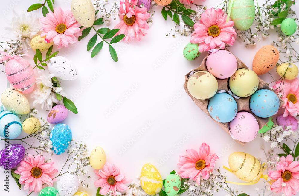 Colorful eggs and flowers on a white background. Easter design in pastel colors with space for text Colorful eggs and flowers on a white background. Easter design in pastel colors with space for text