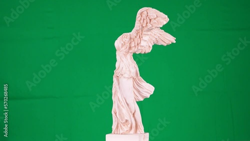 green screen background and solo female sculpture with wings, ancient god of victory Nike with a marble art work greek mythology photo