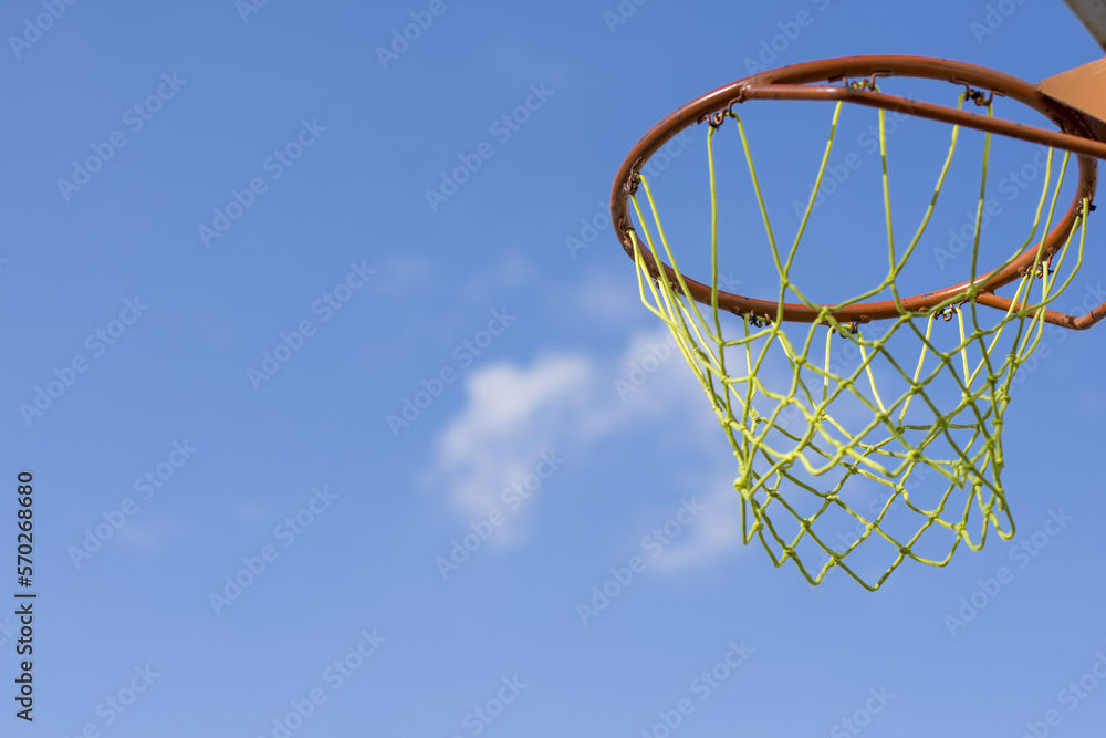 Basketball hoop on blue sky 