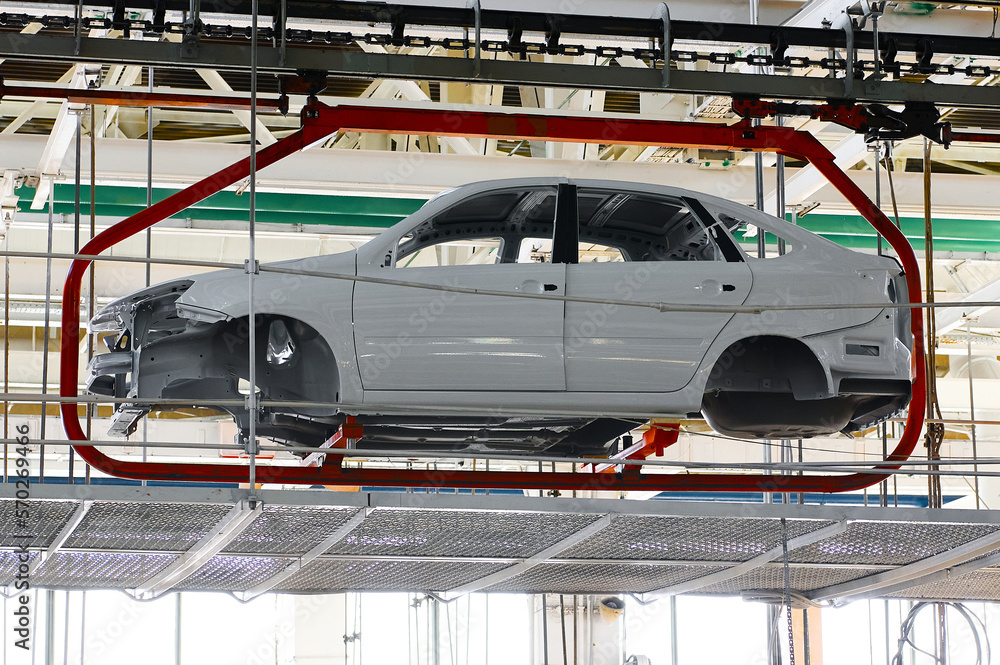 Car body transported by hanging conveyor in plant workshop