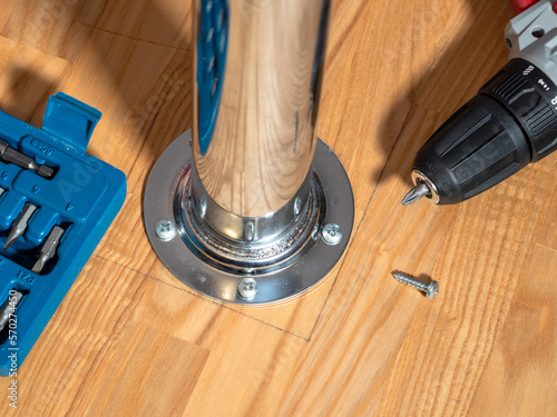 above view of screw-attached table leg and electric screwdriver close up