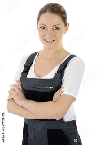 Female mechanic or craftsman in dungarees as work clothes, isolated on white in studio