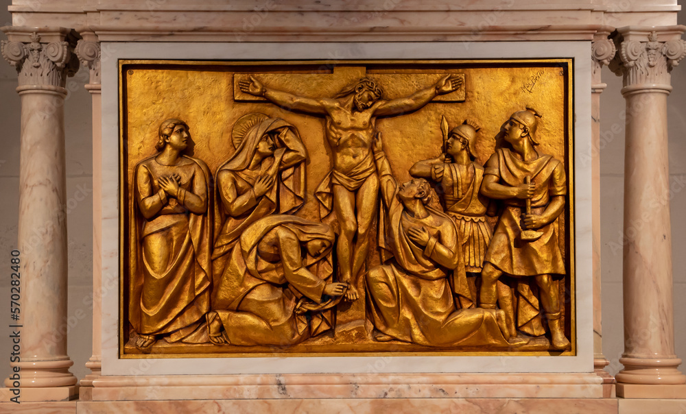 A close-up of a bronze bas-relief representing Jesus crucified, in the Basilica of Fatima - Portugal