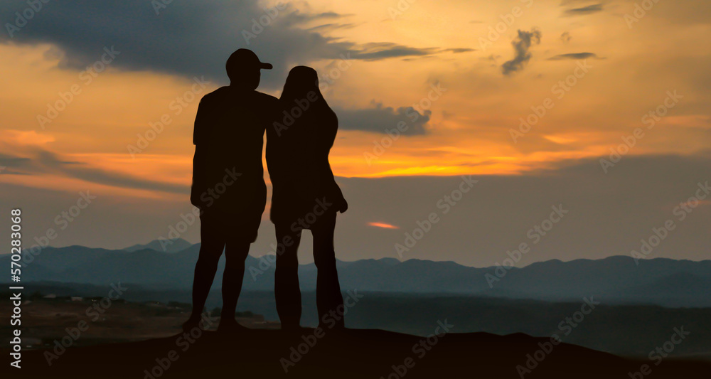 Silhouetted loving couple at sunset.