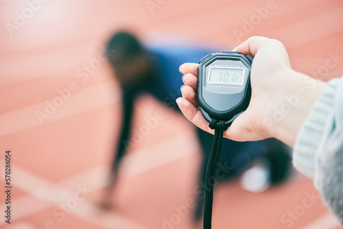 Sports, running and hands with stop watch on race track for exercise, marathon training and fitness. Stadium, workout and athlete team with timer for performance, lap speed and racing competition