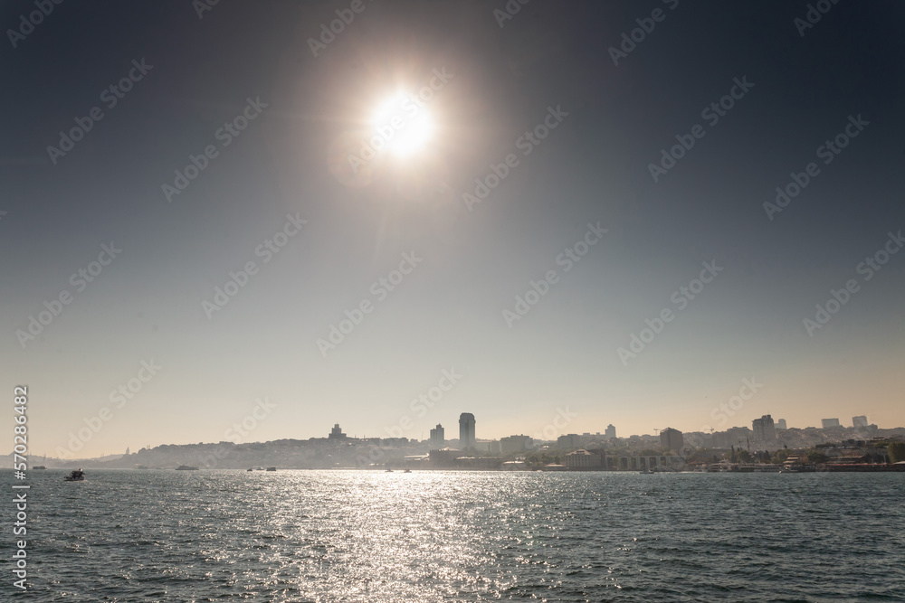 Panorama of the European of Istanbul into the light during a sunny summer afternoon with the skyline of skyscrapers, the hill of Beyoglu and the port of Besiktas. Istanbul is the biggest turkis city.