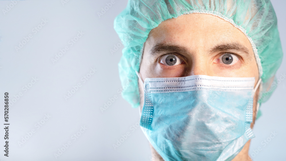Close up of surprised and worried doctor's face protected by a mask. Selective focus Close up of surprised and worried doctor's face protected by a mask. Selective focus