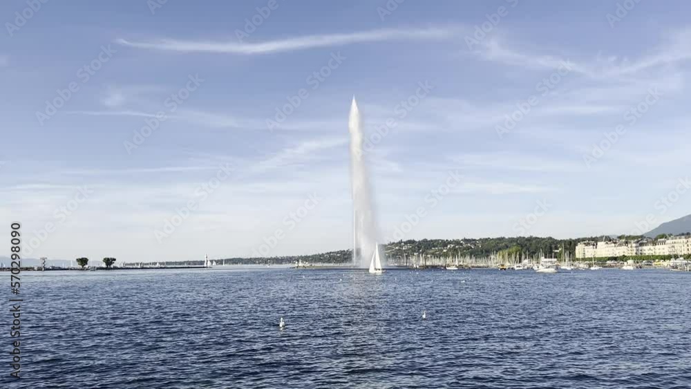 Jet d'Eau fontain in Geneva with rainbow and touristic boats Jet d'Eau fontain in Geneva with rainbow and touristic boats