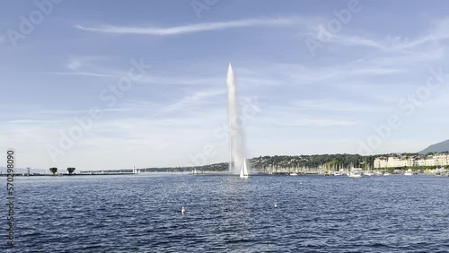 Jet d'Eau fontain in Geneva with rainbow and touristic boats