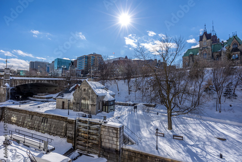 Having a walk in the Majors Hill Park in downtown Ottawa Canada with view to historical buildings at a cold but sunny day in winter.