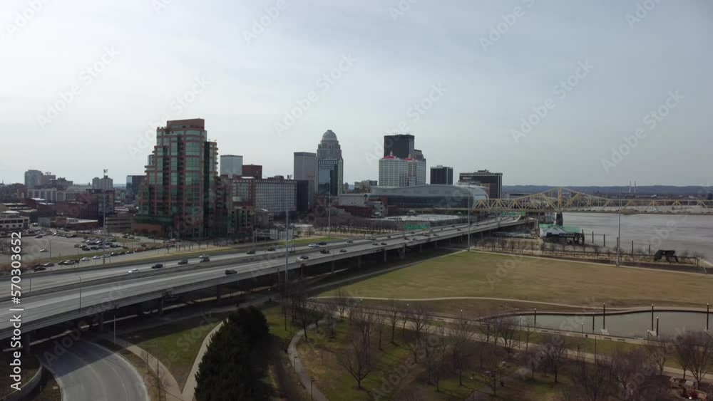 The flow of vehicles on the highway between the Louisville, KY skyline and the Waterfront Park situated beside the Kentucky River. The flow of vehicles on the highway between the Louisville, KY skyline and the Waterfront Park situated beside the Kentucky River.