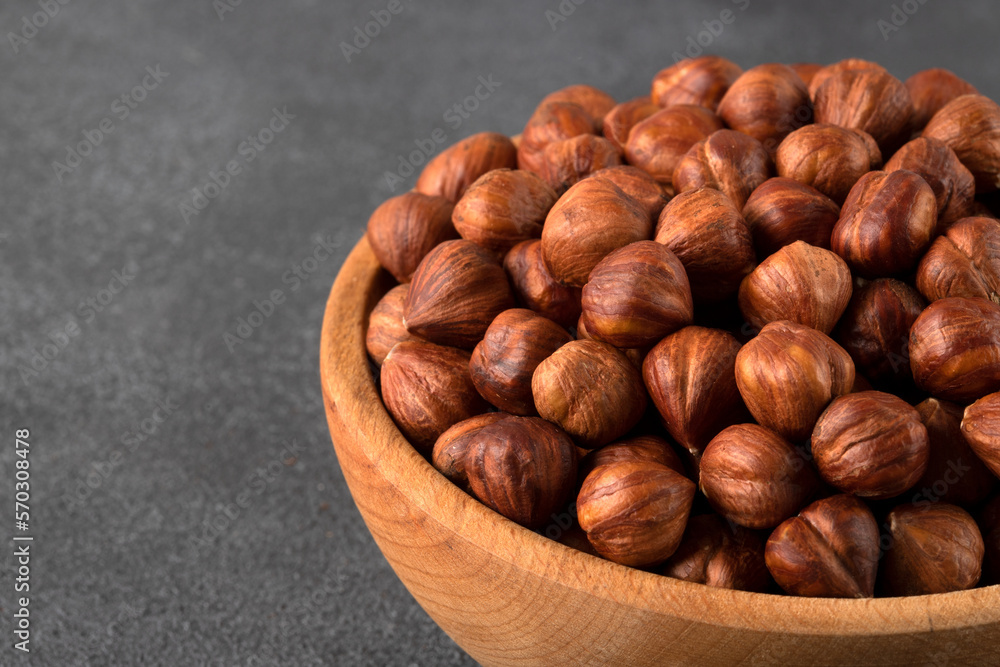View of a bowl full of hazelnuts on a black background
View of a bowl full of hazelnuts on a black background