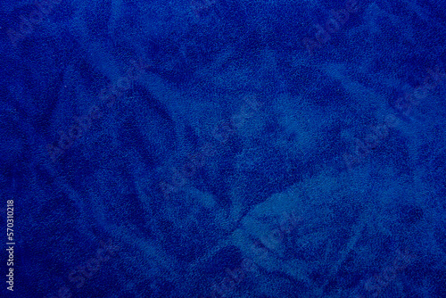 Texture of blue grained leather as a background. Natural material, top view.