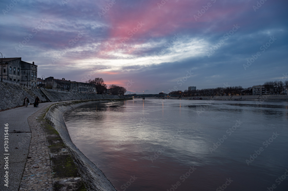 Arles, Provence, France, Promenade at the banks of the River Rhone during a colorful sunset