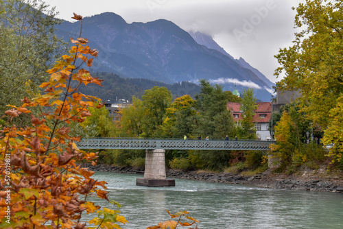 Panoramic view of the historic city center of Innsbruck with colorful houses along Inn river.