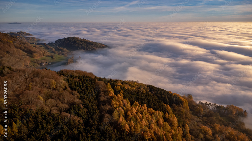 Beautiful sunset with an inversion that looks like a flowing sea. Colorful trees in autumn. Sunset under Jested. Photographed by drone