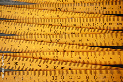 Traditional yellow wooden folding rule with decimal metric system photo