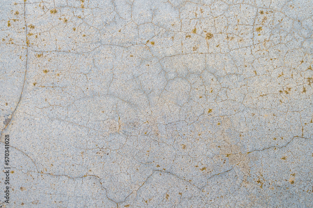 Rough textured surface of an old cracked concrete wall with selective focus on the center. Backdrop Rough textured surface of an old cracked concrete wall with selective focus on the center. Backdrop