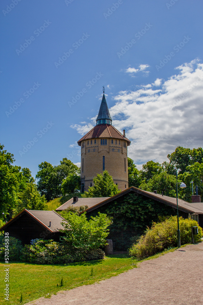 The old brick water tower in the park Pildammsparken during summer in Malmö Sweden