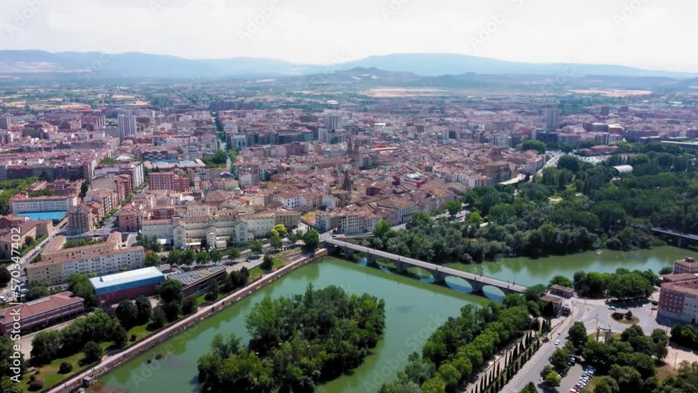 Aerial point of view of Logrono city. View of Ebro River and Puente de Piedra bridge. In background is the city center of Logrono. Drone truck left and right pan. Beautiful panoramic of all region Aerial point of view of Logrono city. View of Ebro River and Puente de Piedra bridge. In background is the city center of Logrono. Drone truck left and right pan. Beautiful panoramic of all region