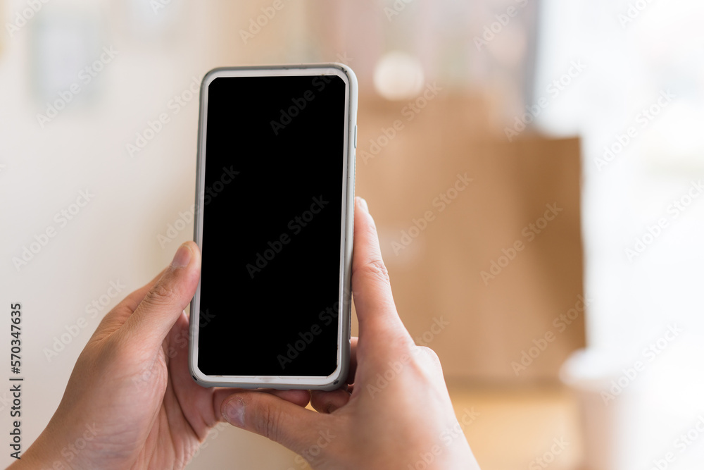 Close up hand of technology in use .  Man working in home office hand smart phone. Concept of using technology in communication.