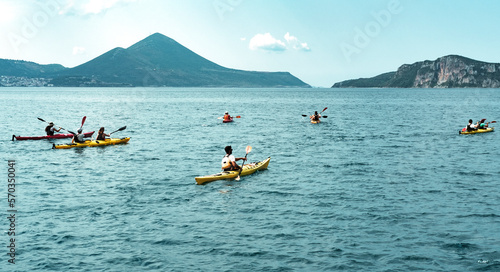 canoe trip in the sea , mountains shore, tourist group making water sports