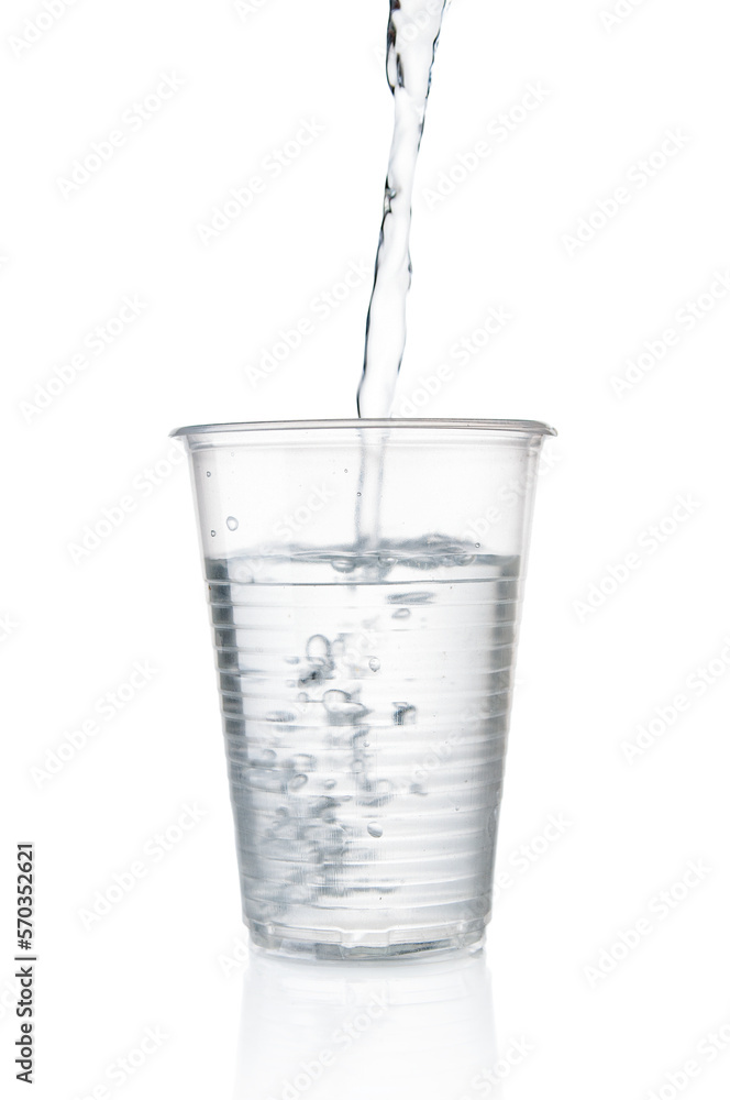 Flowing pure water into disposable plastic cup on white background Flowing pure water into disposable plastic cup on white background