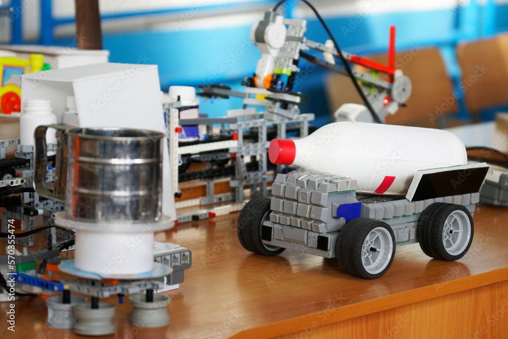 Elements of a toy robotic automated training model for delivering and pouring drinks, making cocktails in a bar or cafe. Selective focus. Elements of a toy robotic automated training model for delivering and pouring drinks, making cocktails in a bar or cafe. Selective focus.