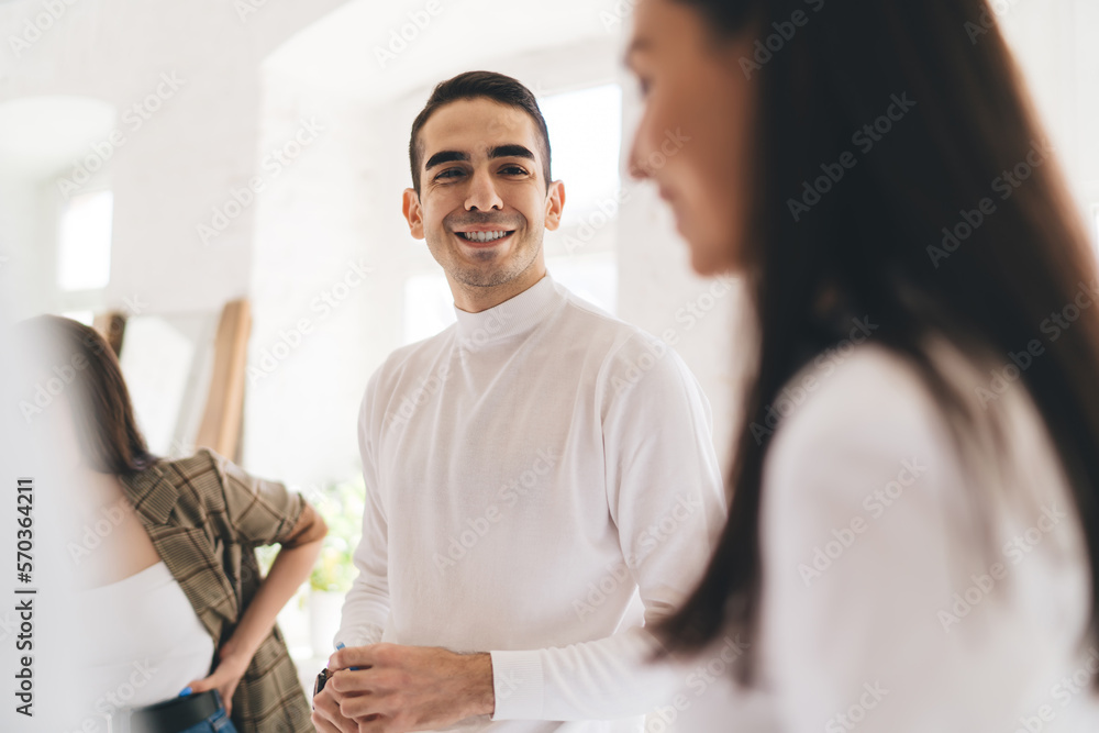 Fototapeta premium Cheerful multiethnic colleagues communicating during break in office