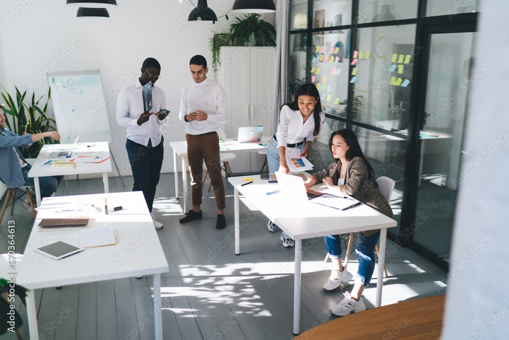 Fototapeta premium Group of multiethnic coworkers discussing while working project in office