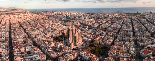 Photography Aerial view of Barcelona City Skyline and Sagrada Familia Cathedral at sunset