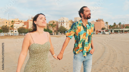 Couple in love walking on the beach hugging each other