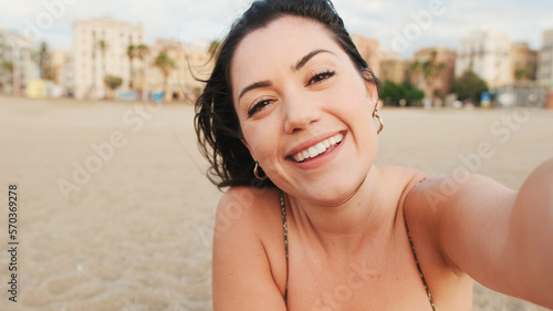 Happy young woman making funny faces and taking selfie