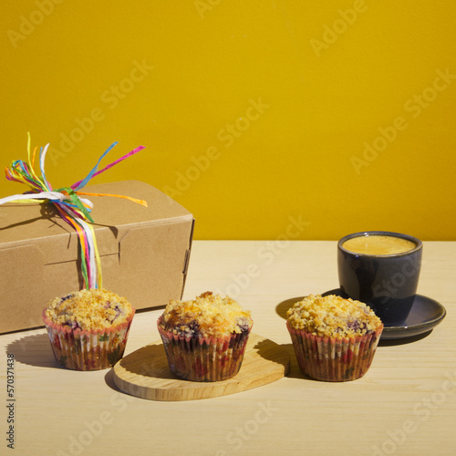 Muffins with a cofee/chocolate and a packaging box. Perfect for bakery advertising and ambience