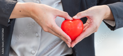 Woman in suit holding red present heart symbol for give gift to man boyfriend lover in valentine day. businesswoman carry red heart present in hands for romantic date at valentine.