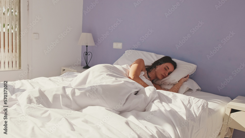 Young woman sleeping in bed early in the morning Young woman sleeping in bed early in the morning