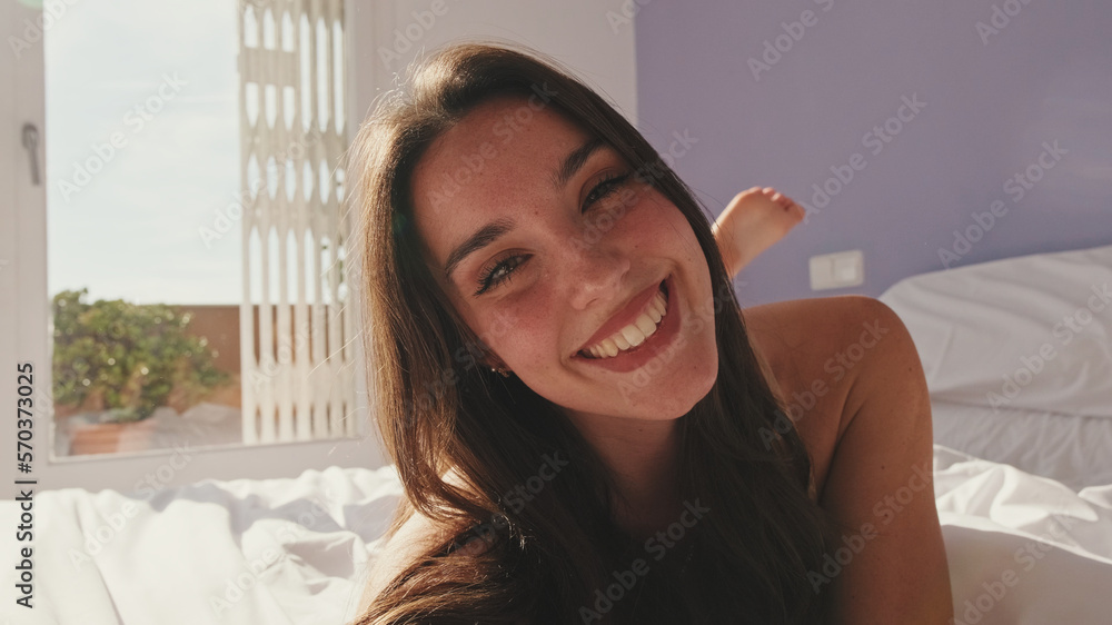 Close-up, happy girl posing lying in bed Close-up, happy girl posing lying in bed