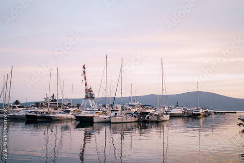 Yachts on the pier against the backdrop of mountains in the evening
