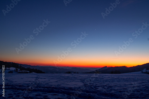 Winter sunset with a snow and clear sky. Photography is from the hills in the Czech republic.