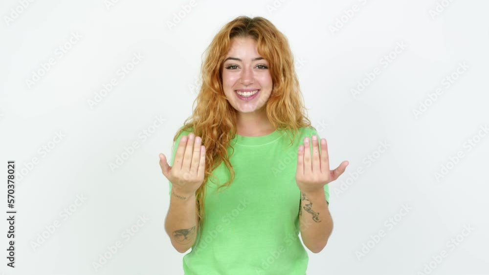 Young redhead woman presenting and inviting to come with hand over isolated background Young redhead woman presenting and inviting to come with hand over isolated background