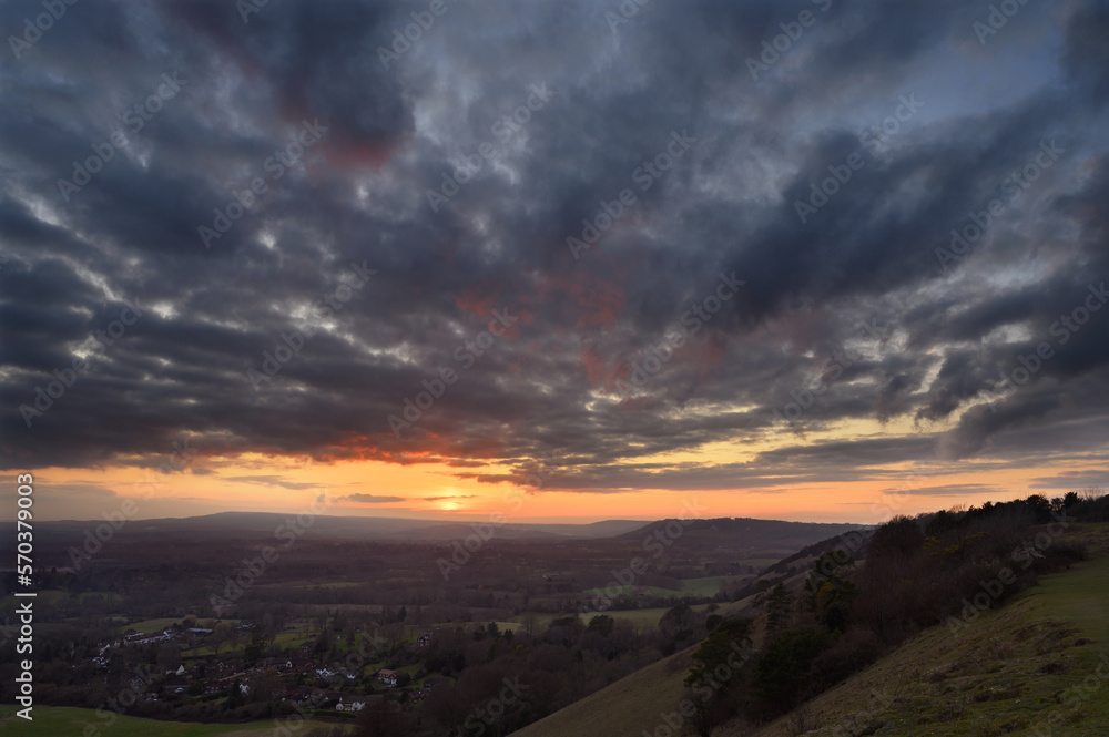 Serene sunset view from Colley Hill between Reigate and Dorking in Surrey, UK. Surrey Hills area of Outstanding Natural Beauty on the North Downs. Looking towards Leith Hill on the Greensand Ridge.