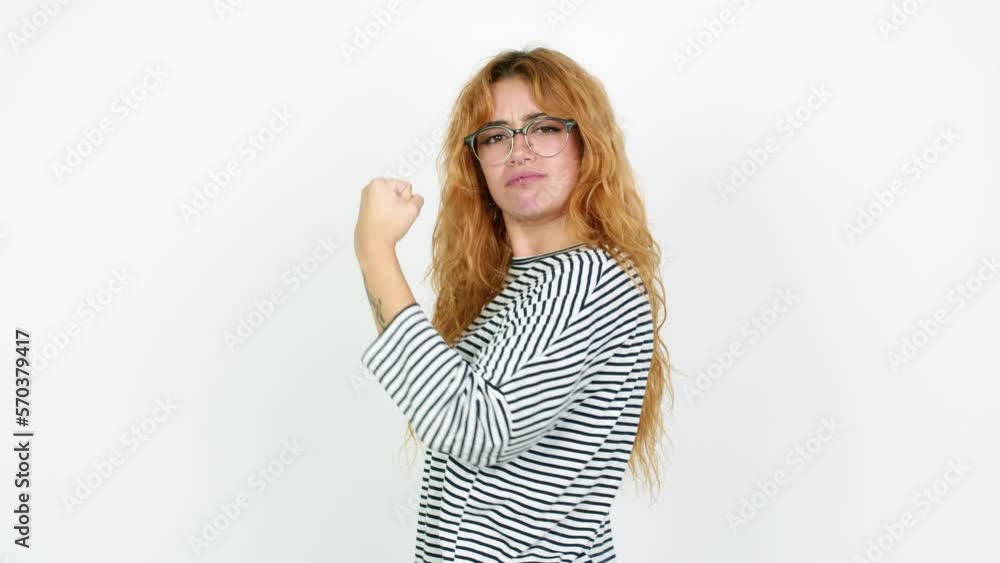 Young redhead woman with glasses and doing winnning gesture Young redhead woman with glasses and doing winnning gesture