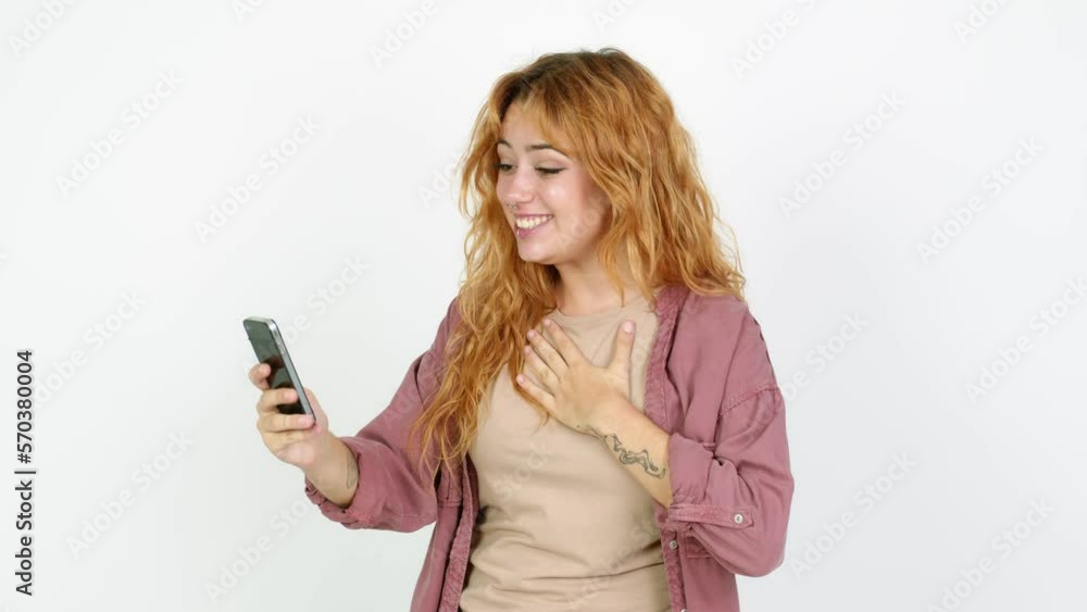 Young redhead woman having a video conference over isolated background Young redhead woman having a video conference over isolated background