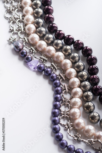 different colors pearls beads pesented together against white background. fashion and jewelry concept