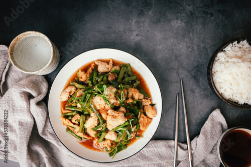 Top view, Stir-fried pork and red hot curry paste with or long bean and Ingredients are oyster sauce, fish sauce, sugar, kaffir lime leaves in the dish Eat with cooked rice. Thai food