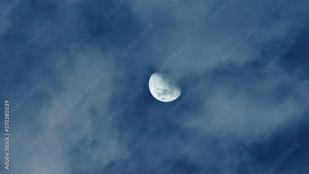Moon in late evening with clouds in the sky Moon in late evening with clouds in the sky