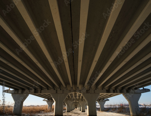 Columns motor vehicle bridge and smooth lines roadway. © freeman83