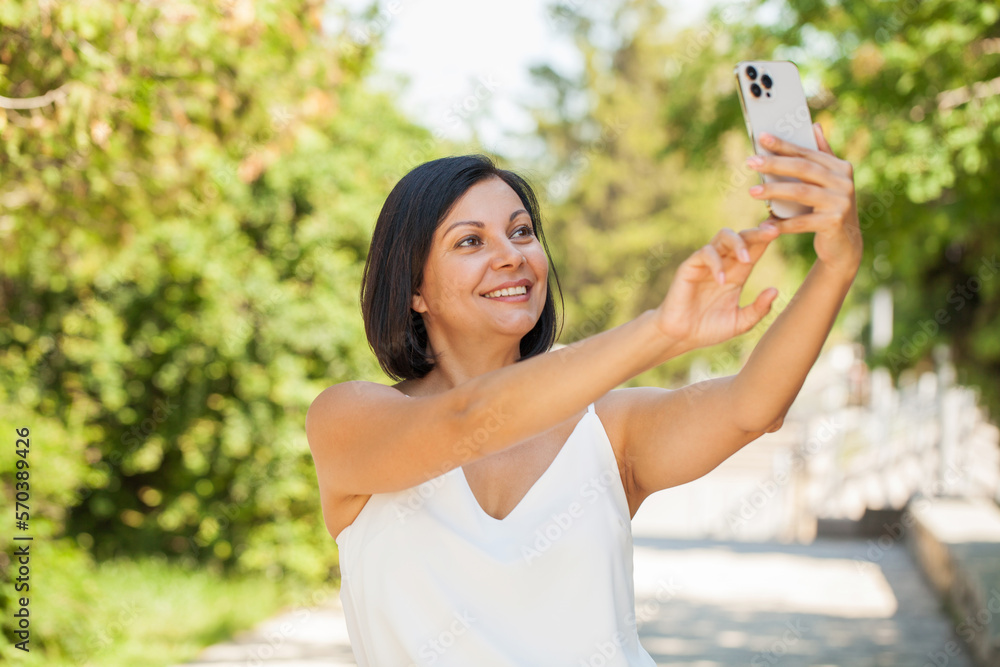 Beautiful brunette middle aged woman with mobile phone Beautiful brunette middle aged woman with mobile phone